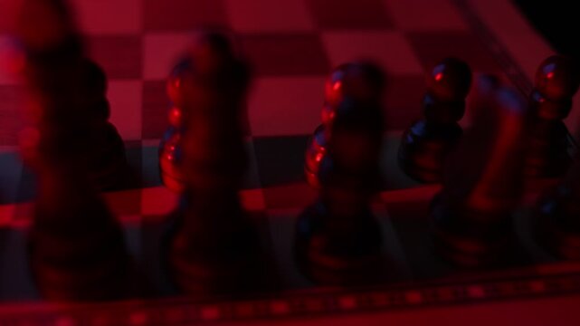 Rotating chessboard with strategically placed pieces in motion, depicting the eternal struggle between black and white factions in cerebral gameplay. disturbing red light, top view, long shadows