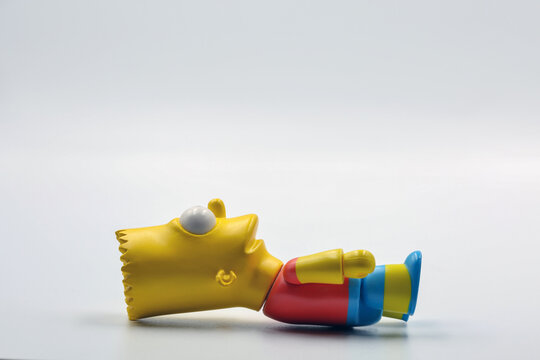 Bart Simpson toy figure closeup on white background.