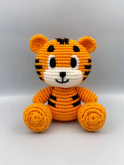 A cute, handmade tiger plush toy, featuring vibrant colors and adorable details. It's a whimsical representation of the majestic animal