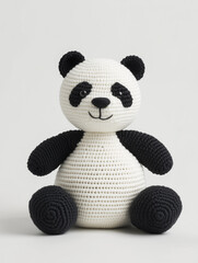 An adorable crocheted panda, showcasing its charming details and unique handmade design. The panda has a classic black and white color scheme