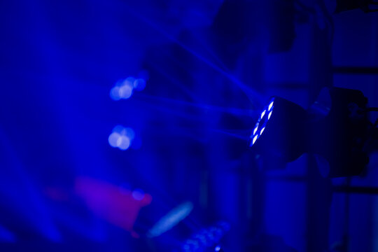 Advanced stage lighting array emitting strong blue light patterns from mounted LED units used in large scale event production and technical show environments