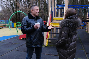 Family values father and daughter are walking in nature lake in fall in cold weather, drinking coffee, laughing, playing on playground, reminiscing about childhood, working out on horizontal bars.