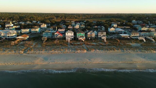 Aerial view of beach front homes and sand dunes in Oak Island, North Carolina