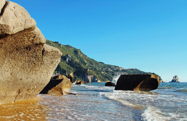 Picturesque sea beach with big stones near Agios Gordios, Corfu island, Greece.