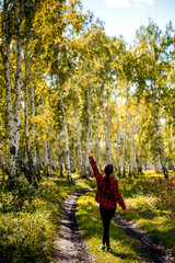 young woman walking in autumn forest