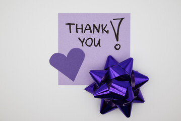 Purple “Thank You” note, symbolizing gratitude, appreciation, and positive communication.