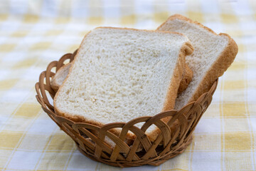 Flattened pieces of white bread in a rustic rattan basket. Ideal for a healthy breakfast..