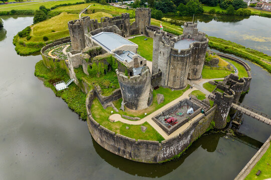 Stone ruins of a medieval 13th century castle surrounded by a large moat