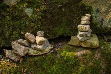 Stacked Prayer Stones on Mossy Rock Surface