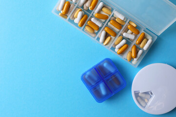 Medications are meticulously organized in a pill organizer placed on a vibrant background
