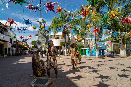 Tlaquepaque, Mexico &ndash; January 12, 2025: El grito continua Bicentennial sculpture with Hidalgo holding standard under pinatas in historic center