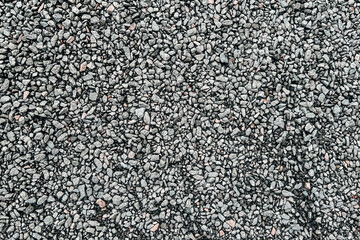 Gray gravel surface with small stones ideal for construction and landscaping projects