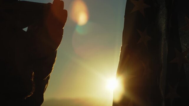 American Soldier Salutes in Silhouette for Memorial Day In Front Of Flag