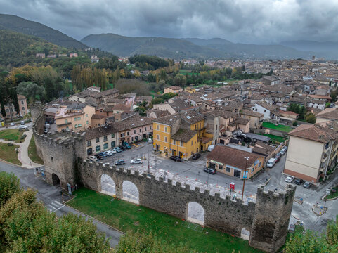 Aerial view of the historic city center of Rieti, city walls, towers, the Velino River, and Mount Terminillo's majestic backdrop