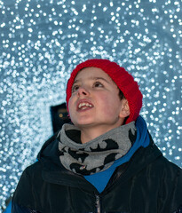 Boy in Red Pom-Pom Hat Looking at Christmas Lights