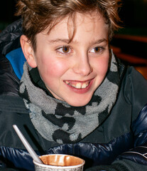 Close-Up Portrait of a Happy Teen Boy Holding Hot Chocolate