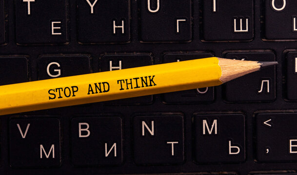 Naklejki In the hands of a man is a cardboard sign with the inscription - Stop Think Act