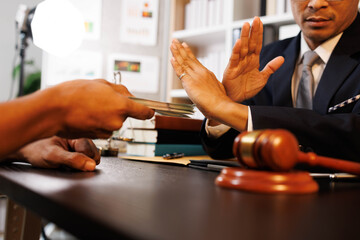 A man is giving money to another man, but the other man is refusing it. The scene is set in a...