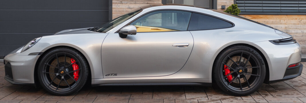 Slovenia, Ljubljana - 5 November 2025: Porsche 911 Carrera GTS parked in a sleek driveway