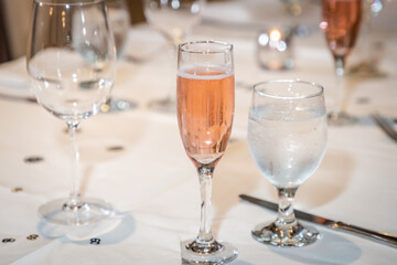 Single glass on rose wine at a table setting