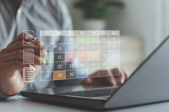 Business planning calendar agenda work schedule and project management concept. Businessman manages time for effective work on laptop with virtual calendar, business event planning. Time management.