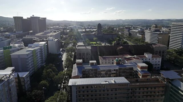 Drone flies west along Minnaar Street, over the natural history museum and the Tshwane City Hall in Pretoria, South Africa