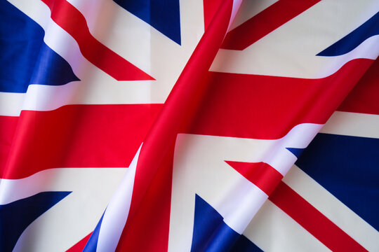 National symbol of Great Britain. British full framed wave UK fabric flag background. Copy space for your text. Concept of Independence