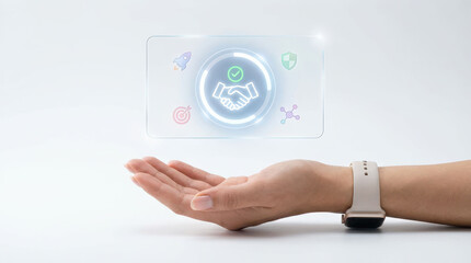 Hand wearing smartwatch is extended digital hologram displaying handshake icon, symbolizing agreement or partnership. hologram includes additional icons like rocket and shield, suggesting