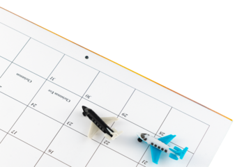 Toy airplanes on a December calendar date showing busy travel days at the holiday
