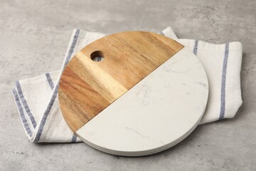One cutting board and napkin on grey textured table, closeup