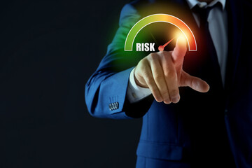 Man regulating level of risk on virtual screen against black background, closeup