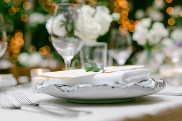 Elegant table setting for a special event with flowers and soft lighting creating a warm atmosphere