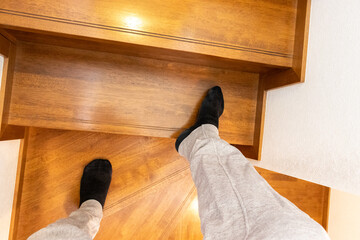 木製の階段を上る人物