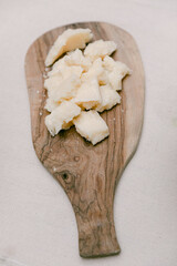 Delicious pieces of cheese arranged on a wooden cutting board during a culinary event