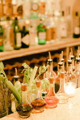 Variety of colorful liquor bottles lined up on a bar counter during an evening gathering