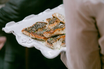Freshly grilled fish served on a decorative platter at a dining event
