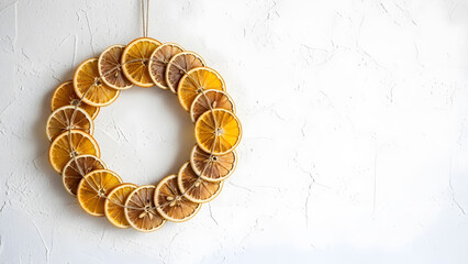 Dried Orange Slice Christmas Wreath Hanging on White Wall