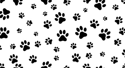 Fototapeta premium A dynamic and engaging seamless vector pattern showcases multiple black animal paw prints of varying sizes scattered across a bright white backdrop.