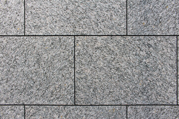 Close up of gray square tile wall texture background.