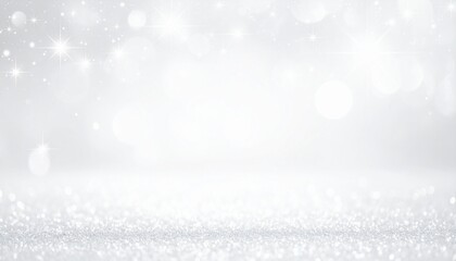 A close-up perspective of a sparkling silver glitter surface fading into a soft, defocused grey background with bokeh lights. 