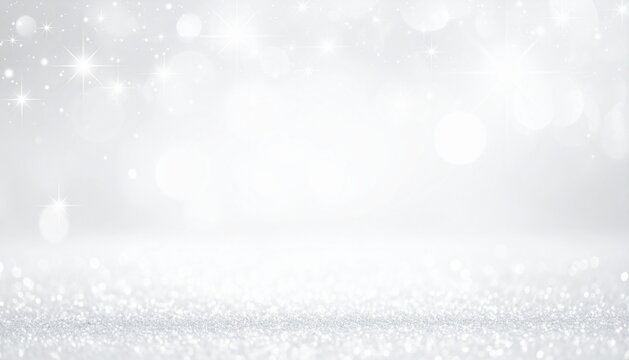 A close-up perspective of a sparkling silver glitter surface fading into a soft, defocused grey background with bokeh lights. 