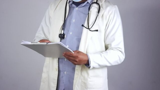 Doctor's hands, documents, and writing in a medical checklist, medical record, or hospital record for patient care or progress. Clinician or surgeon at clipboard, documents, and medical results or rep