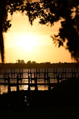 Fototapeta premium private boat docks extend into the Manatee River at sunset in Palmetto, Florida