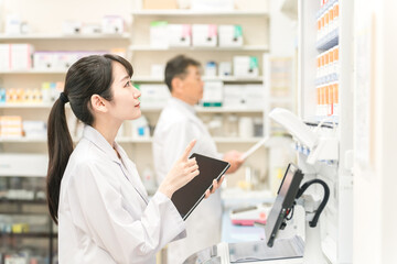Fototapeta premium Pharmacists working in dispensing rooms at pharmacies, hospitals, and drugstores (prescriptions, medicines, supplements) 