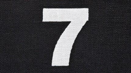 Number seven on black canvas fabric texture for design or decoration