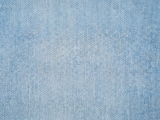 A light blue denim fabric texture with a soft diagonal twill weave. High-detail textile background, evenly lit and seamless for use in fashion, design or graphic projects.