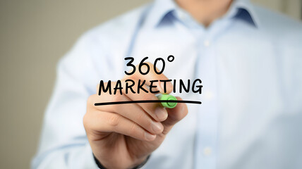Man writing 360 degree marketing strategy on glass with a marker showcasing business solutions and advertising concepts for digital and traditional media campaigns