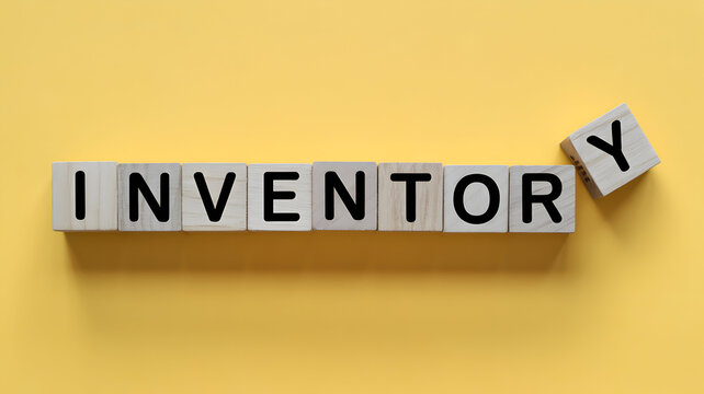 Wooden blocks spelling inventory on a yellow background representing stock management supply chain and business operations for retail and ecommerce success