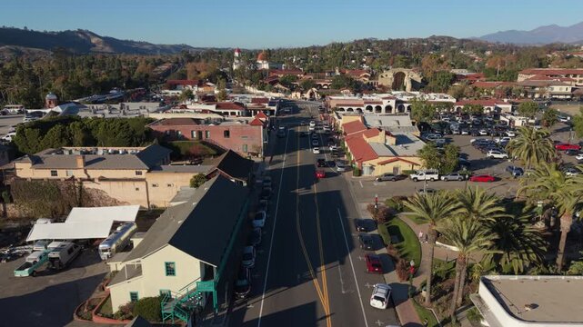 flying over Camino Capistrano street towards San Juan Capistrano Mission