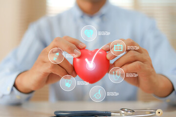 The doctor's hand is choosing the heart with medical health care icons for safety insurance for sick illness wellbeing protection plan or retirement healthy therapy treatment or health checkup